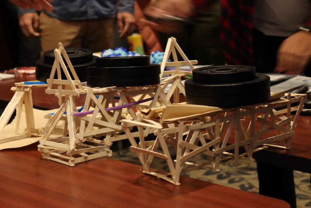 Stick bridges holding weights