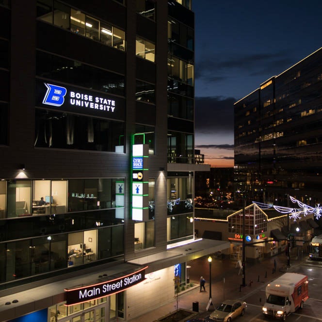 Downtown Boise, Idaho at night with a view of the Main Street Station and Boise State University office