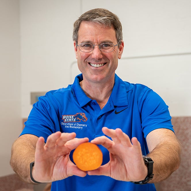 Professor Owen McDougal holds a cross section of a yam
