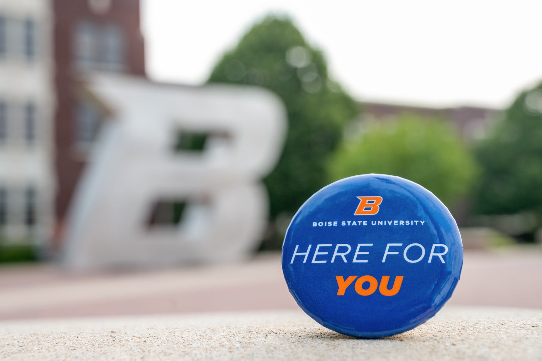 Boise State "Here For You" pin with B statue in background