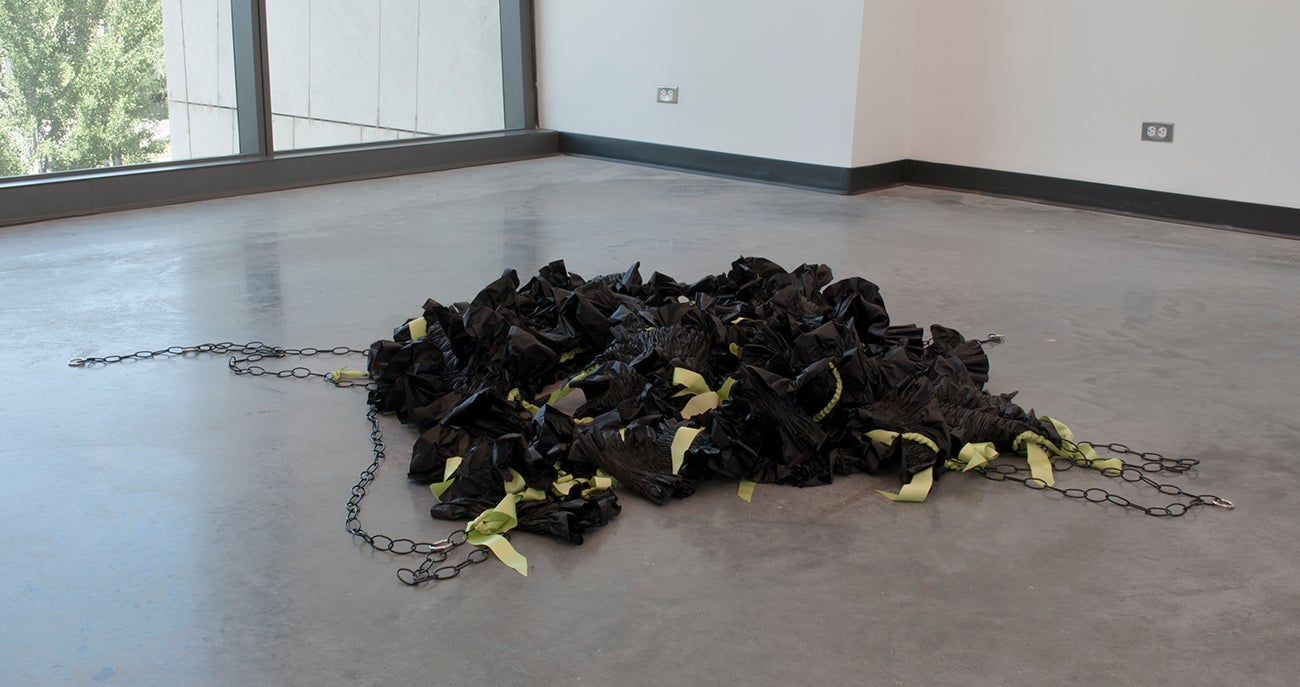 “Portrait of a Former Self” abstract sculpture with plastic table cloths, satin, thread, chain, findings.