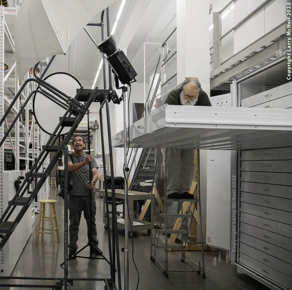 Larry McNeil working alongside curator Steve Henrickson at the Alaska State Museum in Juneau, Alaska.