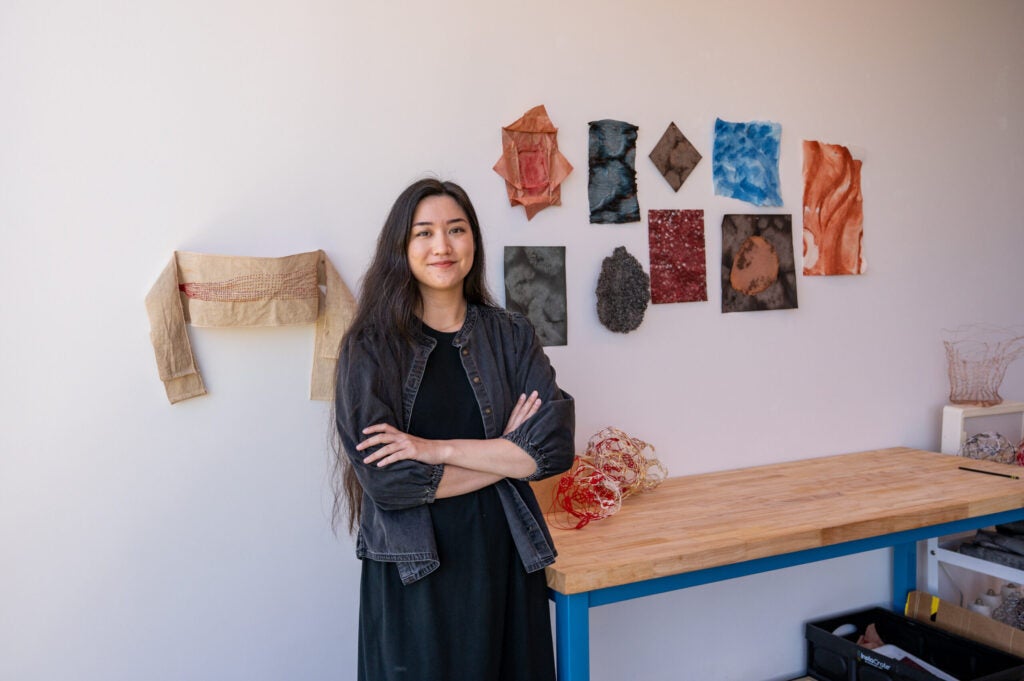 Hallie Maxwell standing in front of sculptures