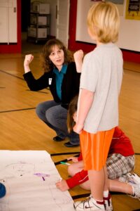 service learning student works with elementary students on a project