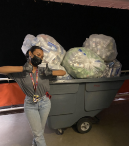 Boise state student with a pile of bags filled with recycling
