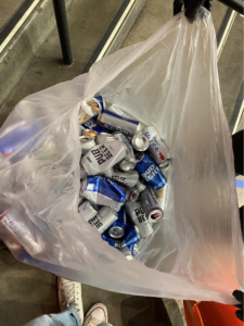 Recyclable cans inside a trash bag