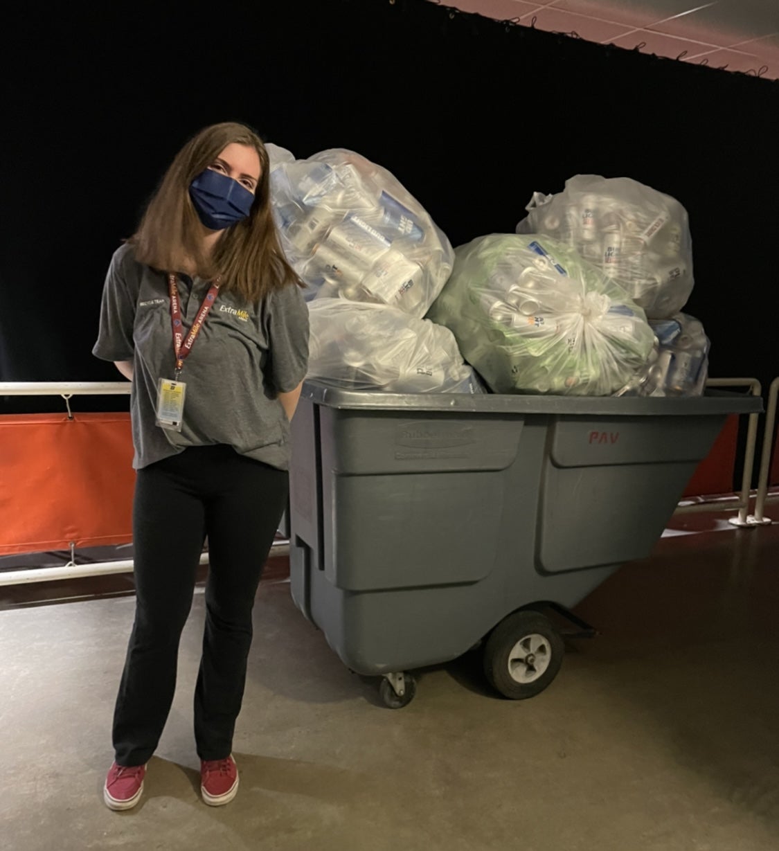 Boise state student with a pile of bags filled with recycling