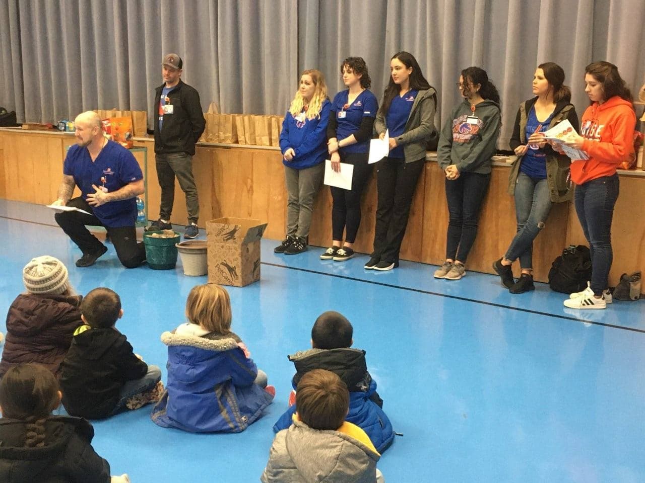 Boise state nursing students standing in front of seated elementary students