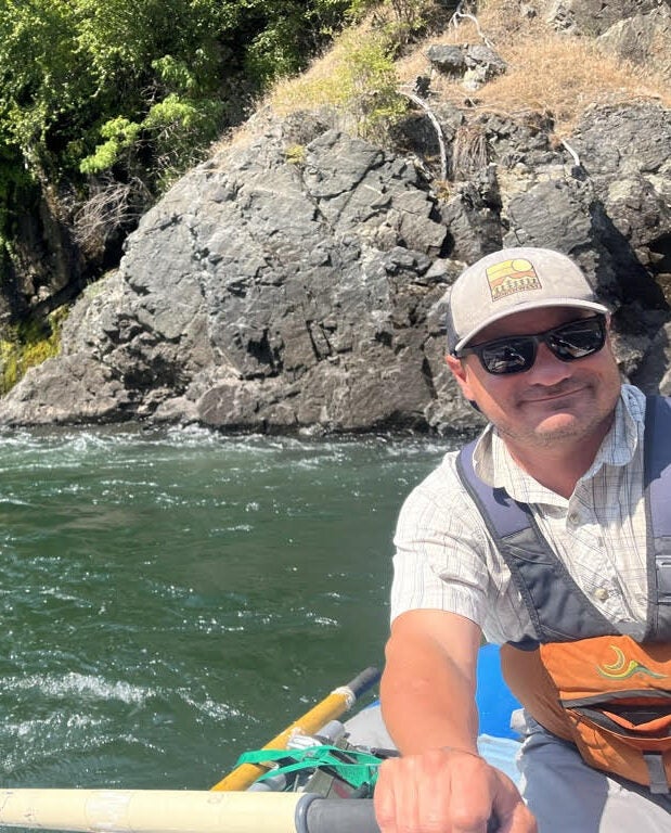 Allen Traylor in a boat on a river