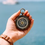 Hand holding compass