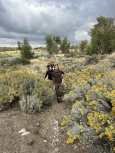 Students stand in a field with sagebrush