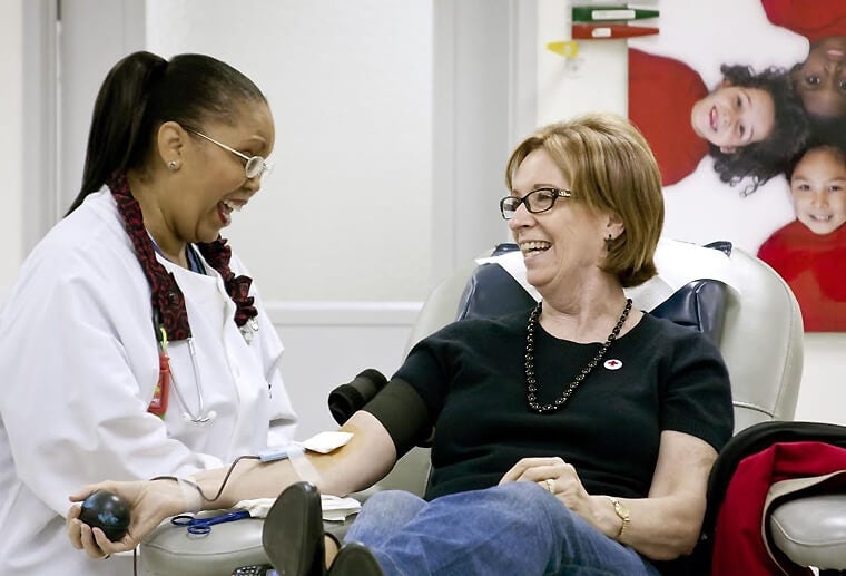 A woman donates blood. 