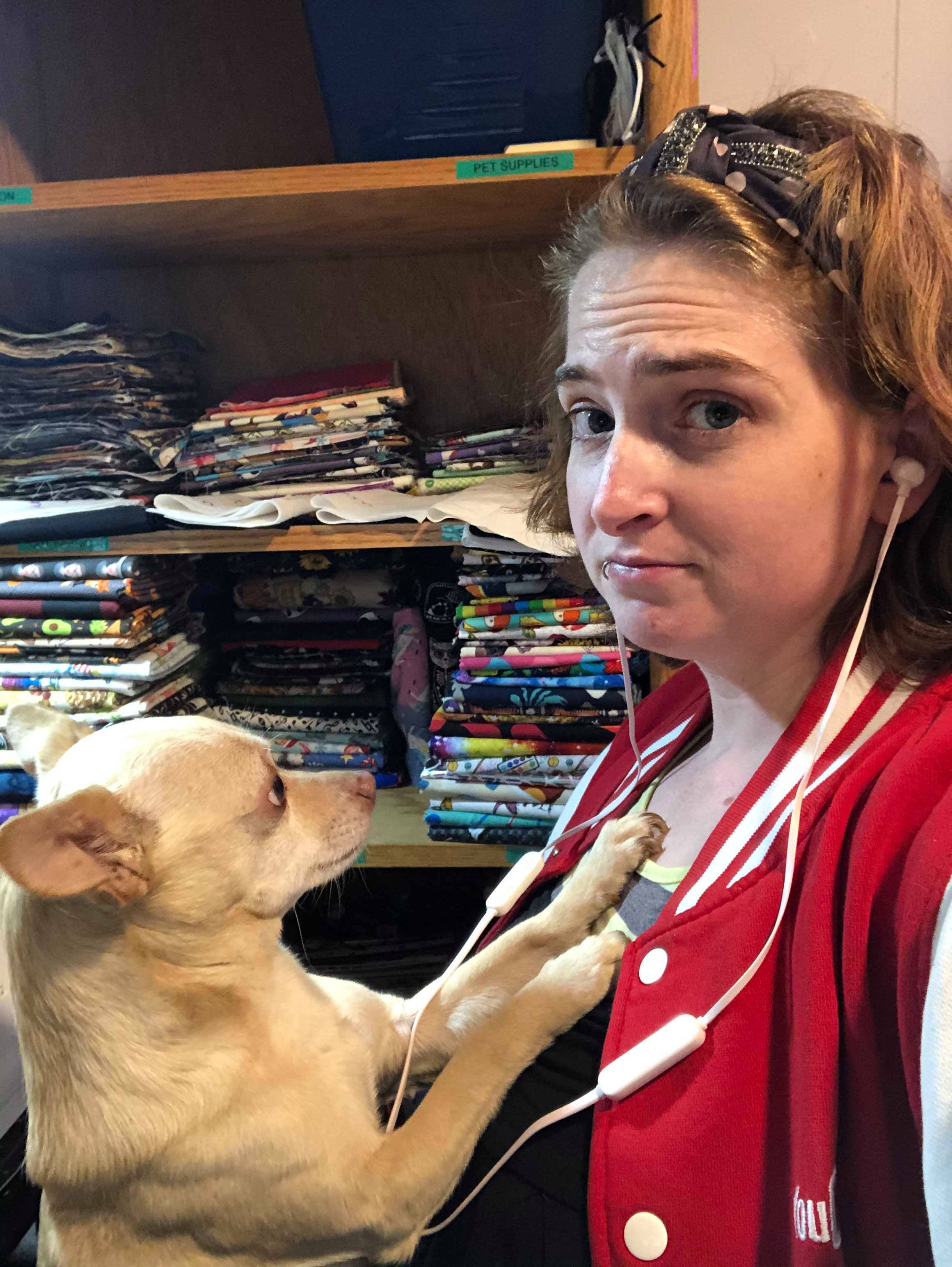 Kym with her white chihuahua dog.