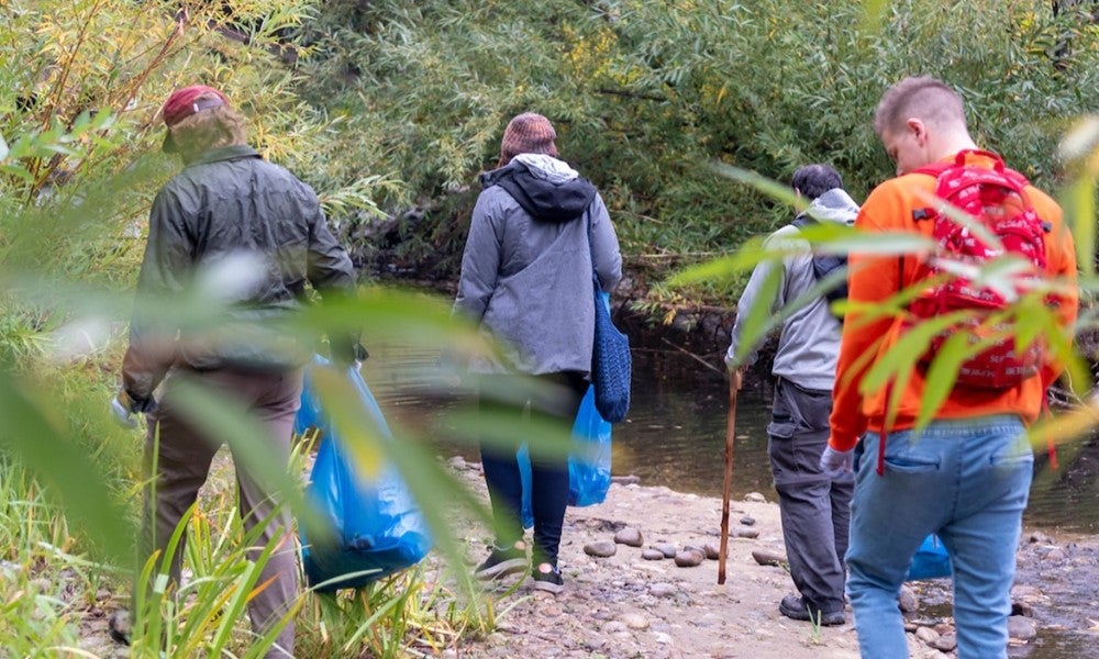 Students cleaning trash on river banks
