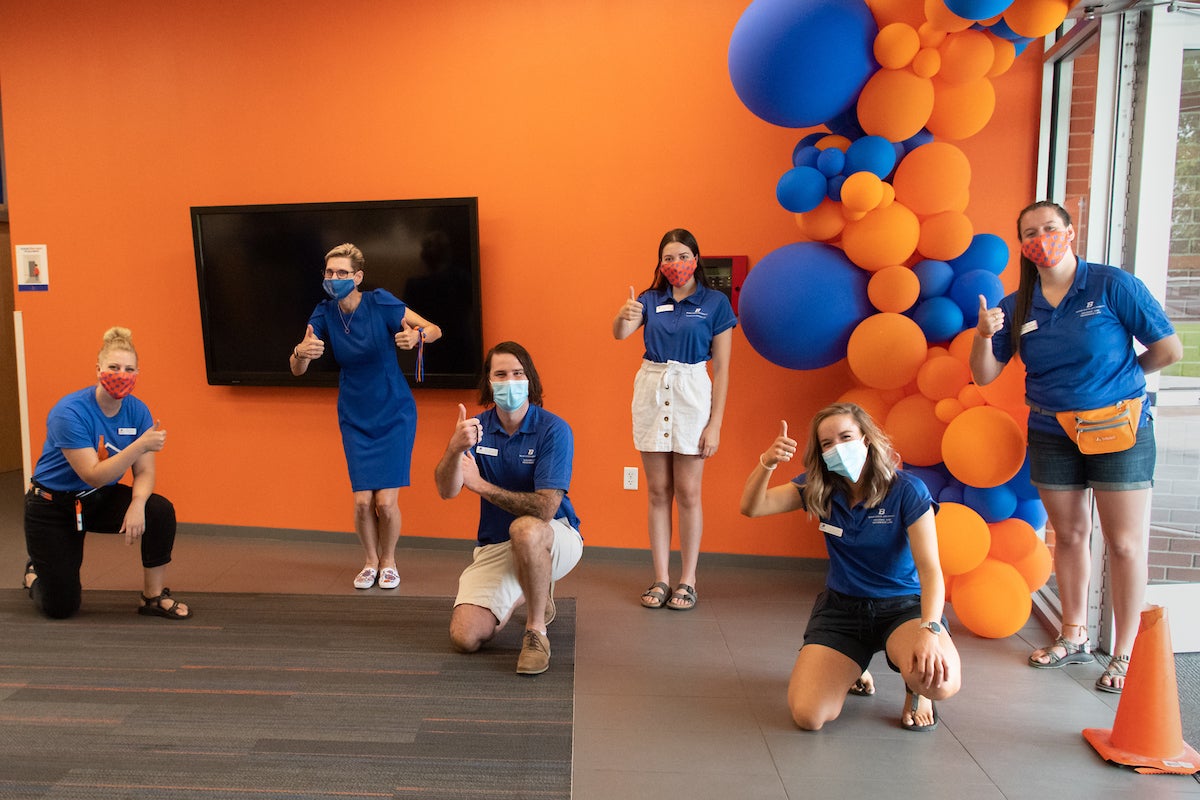 Dr. Tromp and staff, wearing masks and giving thumbs up