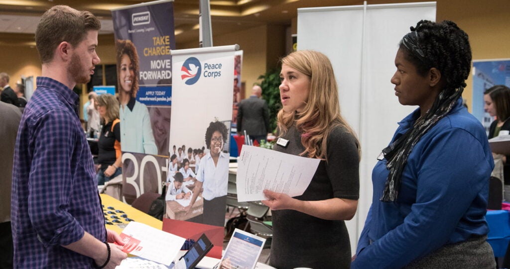Students speaking with potential employers at career fair
