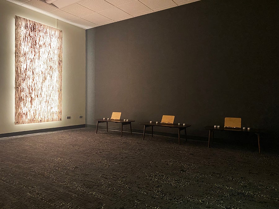 Open room with filtered light and seats against wall