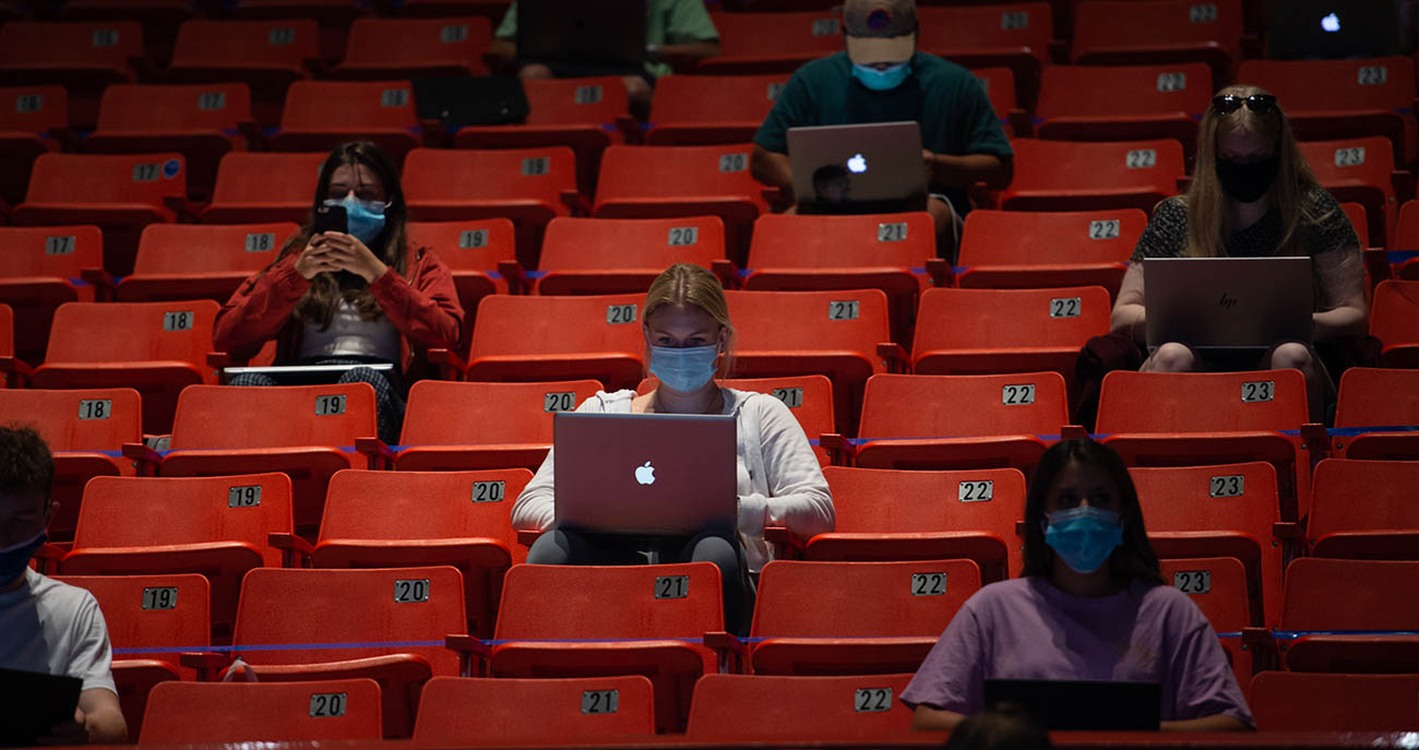 Students sitting, wearing face masks and socially distanced