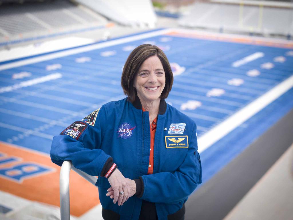 Barb Morgan in front of blue turf
