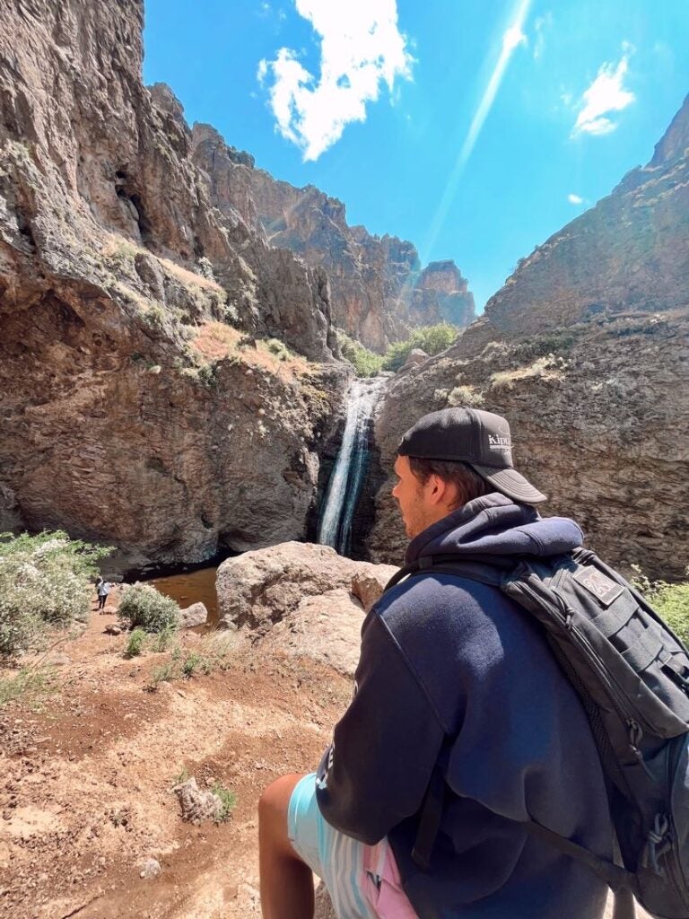 Ryan Dougherty hiking near a waterfall