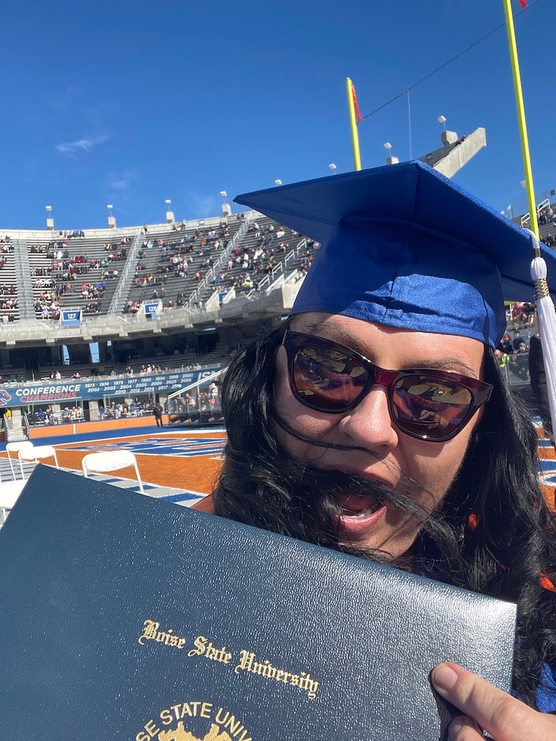 Moore at commencement with her diploma