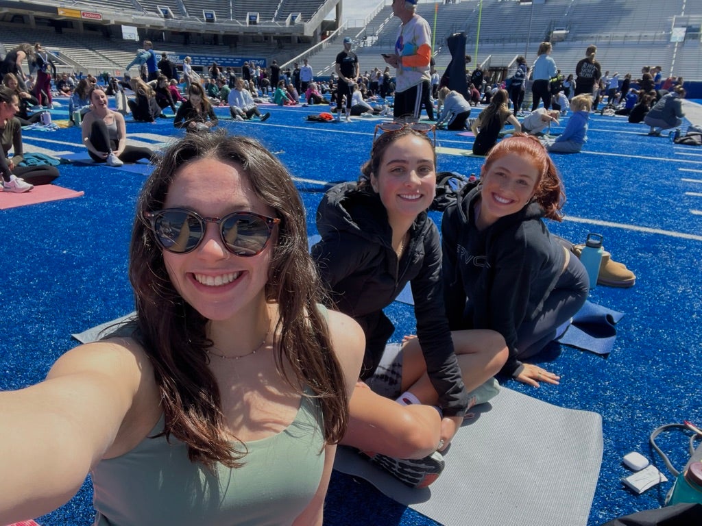 Selfie of students hanging out on the blue turf