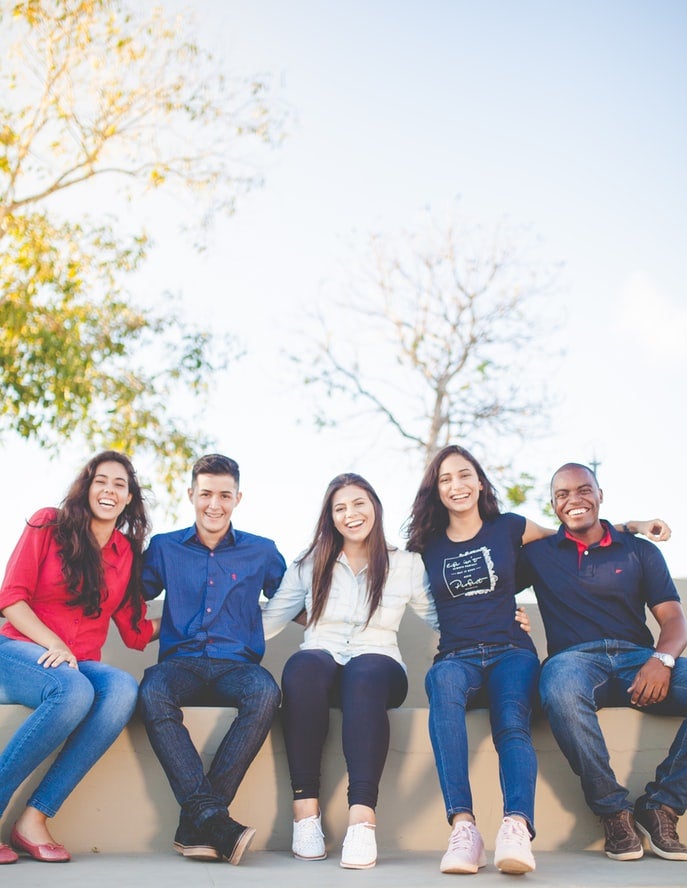People sitting while smiling for a picture