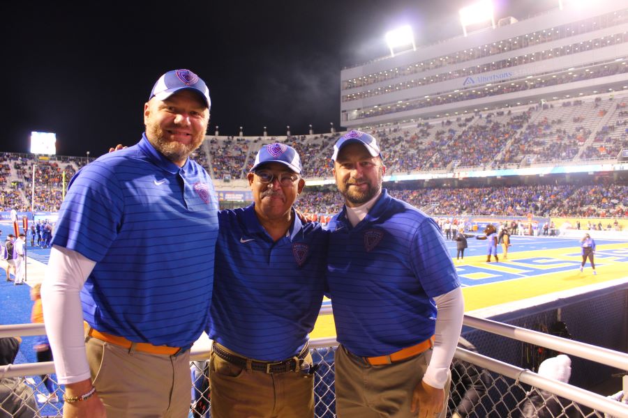 Blue Thunder Staff stand in front of BSU football field