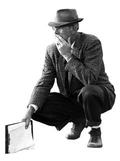 Smith kneels while holding a clipboard
