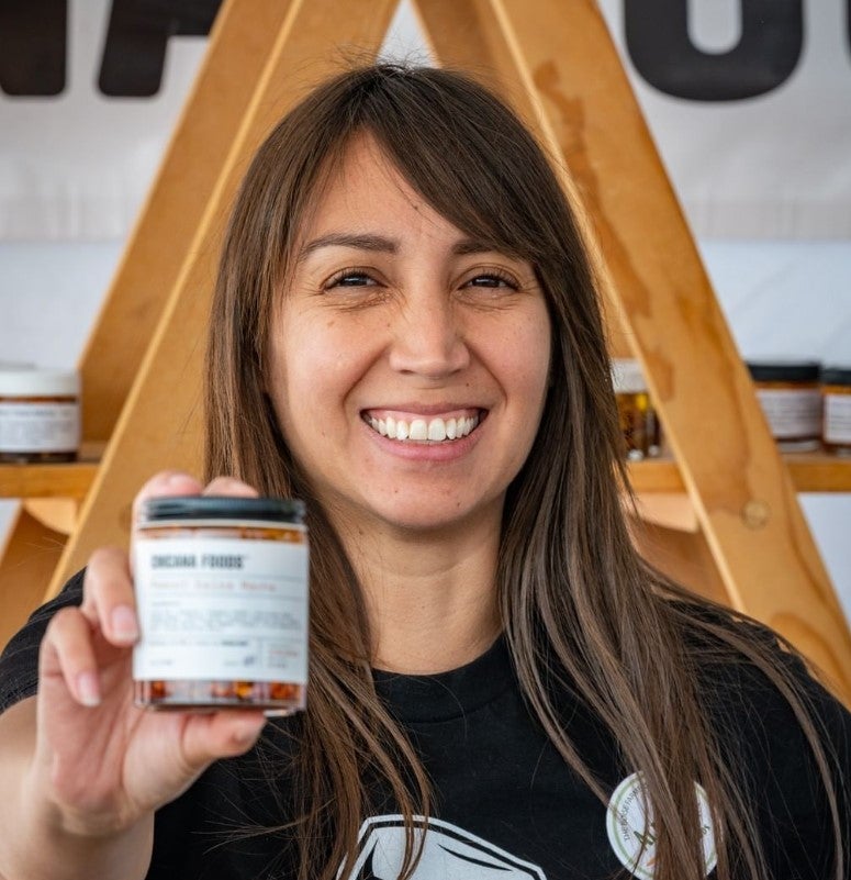 Allison Corona from Chicana Foods Holds Up Her Homeade Salsa Macha