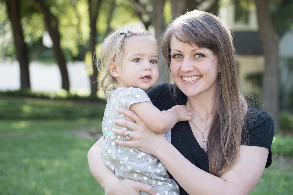 mother holder her child and smiling