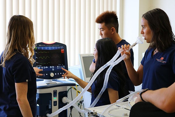 Students demonstrating a ventilator