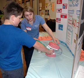 TaftFair2 Nursing student teaches student about proper technique for brushing teeth