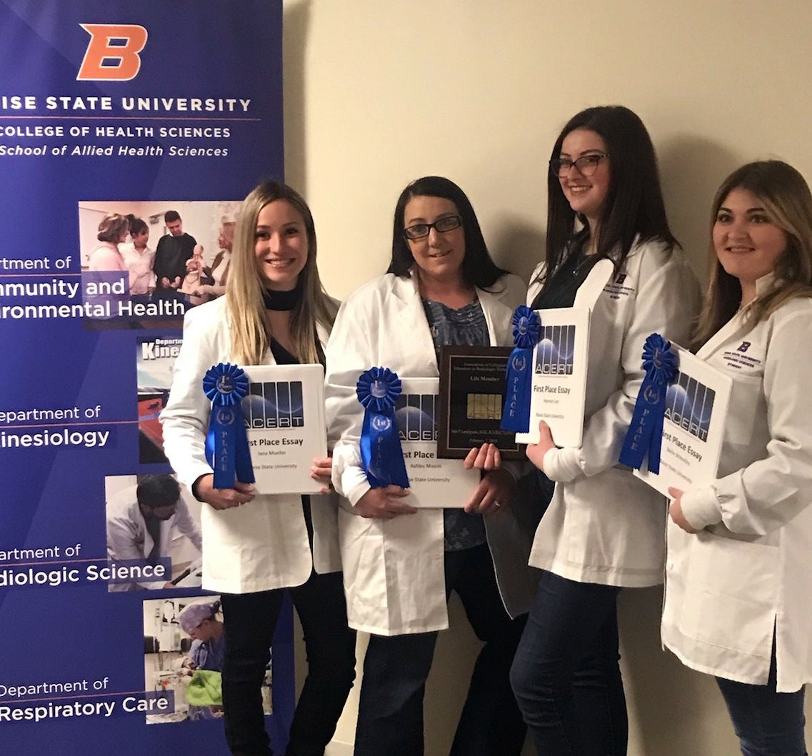 Student essay competition winners Jana Mueller, Ashley Mason, Hannah Lee, and Bailie Lane (left to right)