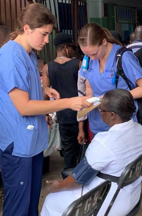 Abbey providing basic care to a ghana citizen