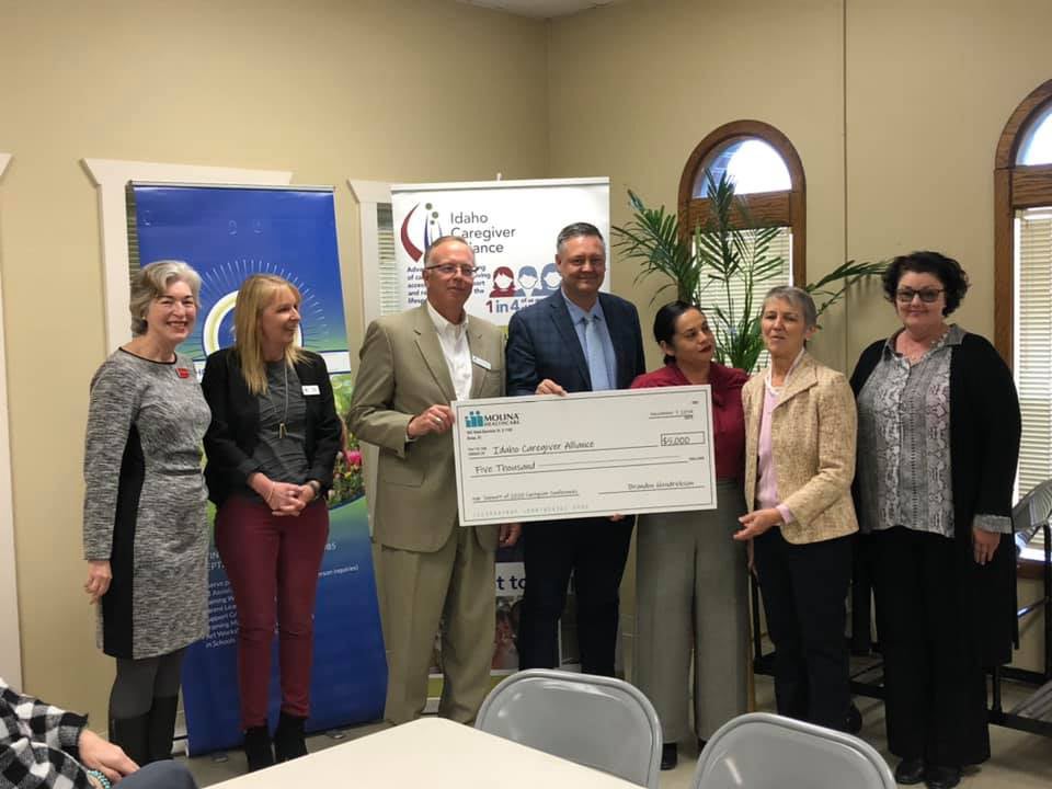 Tim receiving the check on behalf of the center
