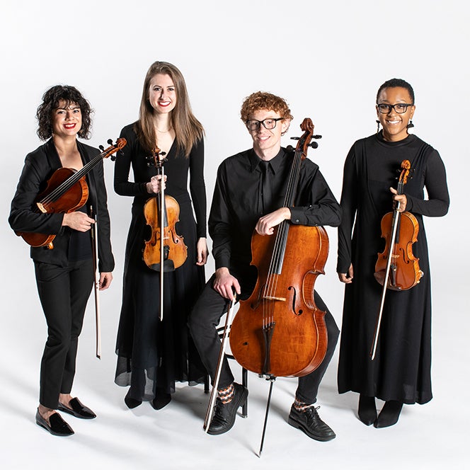 Four people hold their instruments