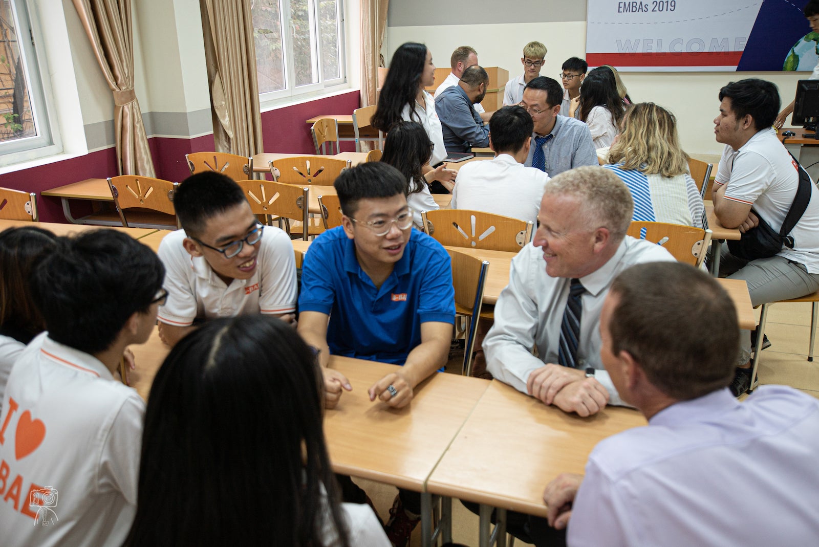 Executive MBA participants Brian Shields and Shannon Boroff visit with Vietnamese students.