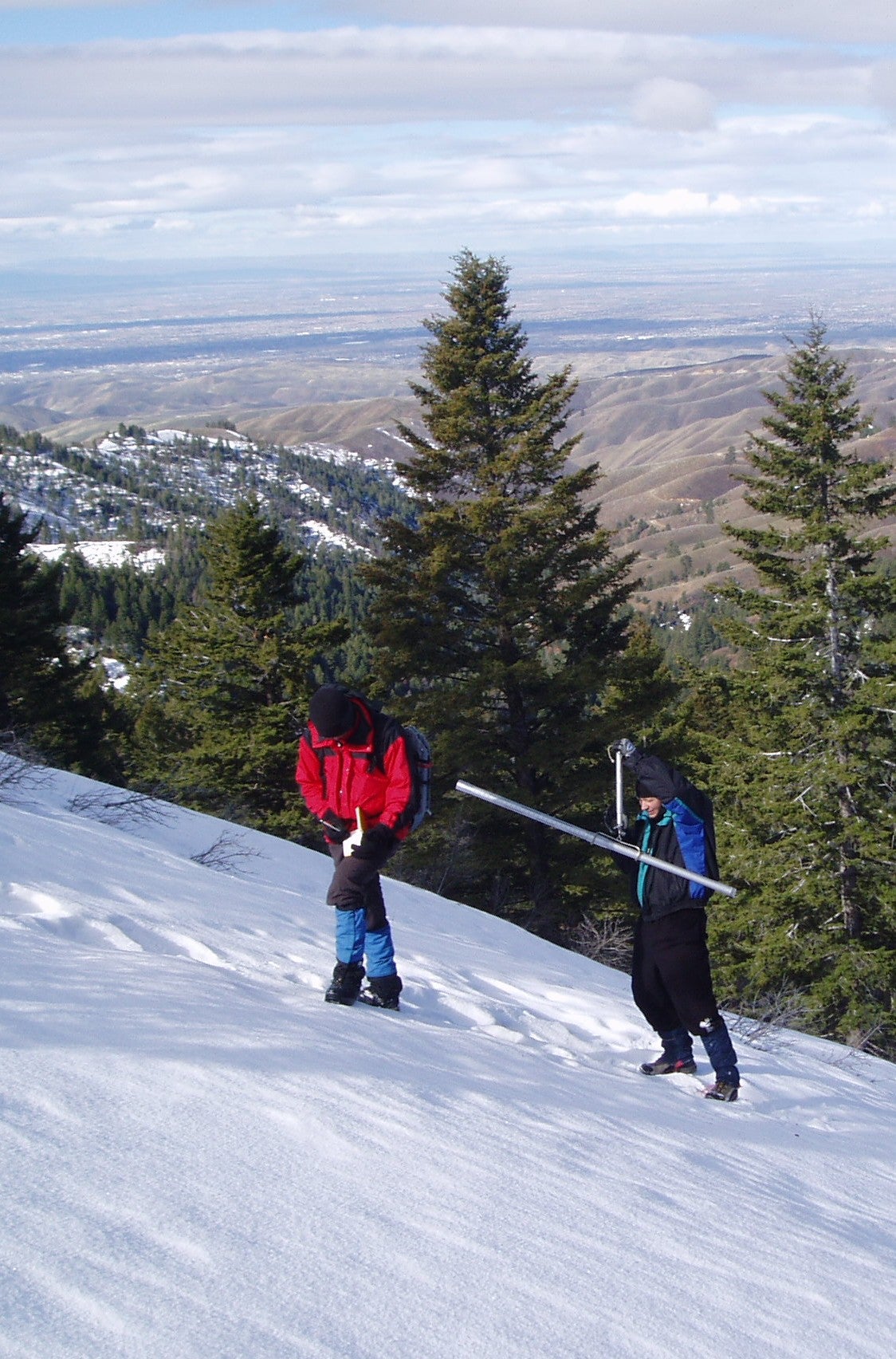 Researchers collect data in the snow.