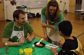teachtalk students painting with child